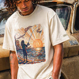 man standing in front of a truck wearing a pearl colored shirt with a colorful graphic of a person fishing
