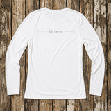 White long-sleeve shirt with 'be pono' text on a wooden background
