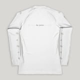 White long-sleeve shirt with grey "be pono" text on the back and flowers on the sleeves on a gray background