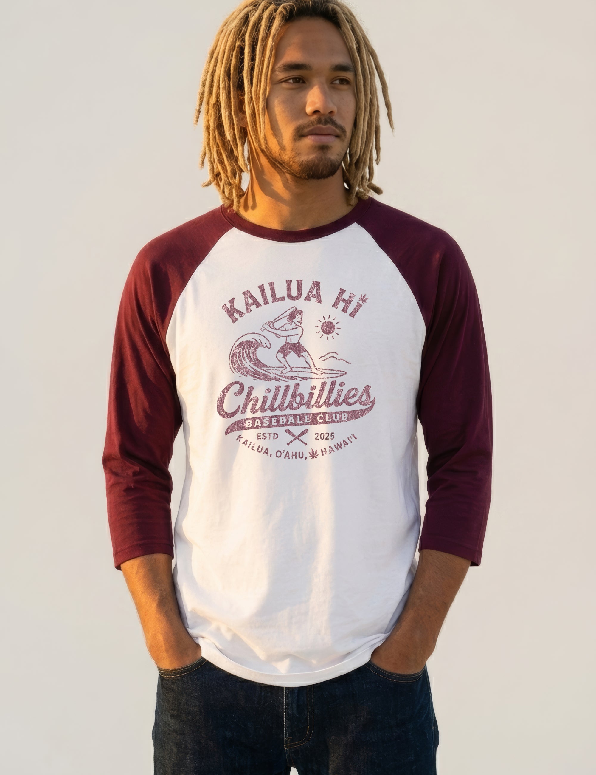 Person wearing a maroon and white baseball shirt with text and graphics on a plain background