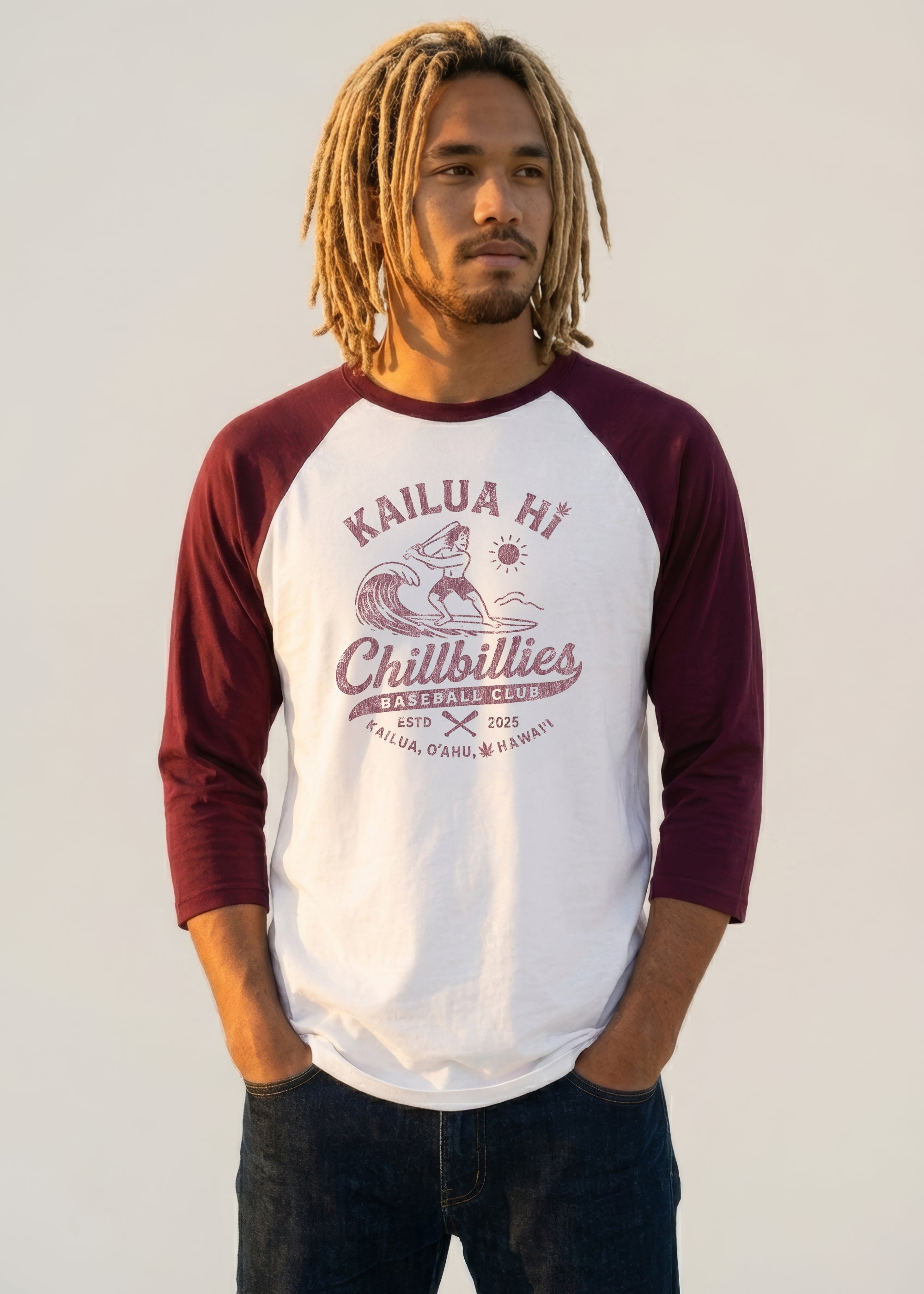 Person wearing a maroon and white baseball shirt with text and graphics on a plain background