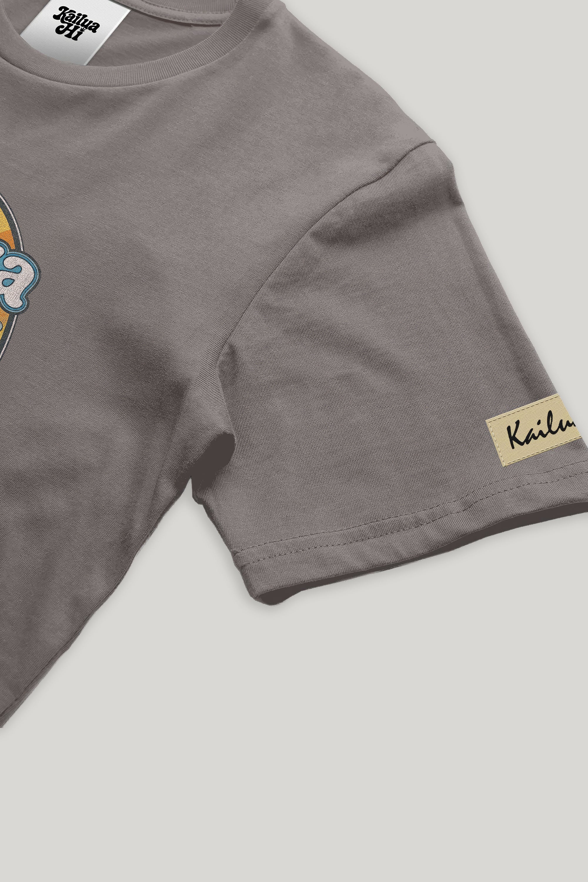 Gray t-shirt with a kailua hi logo on a light gray background