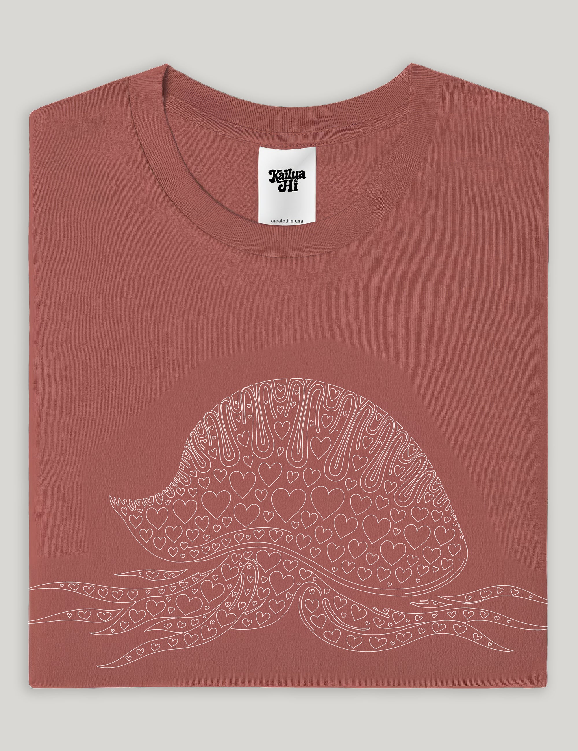 Coral t-shirt with a white man-o-peace graphic design filled with hearts on a light gray background