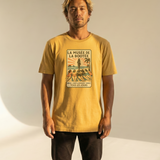 Man wearing a yellow t-shirt with a graphic design on a plain background