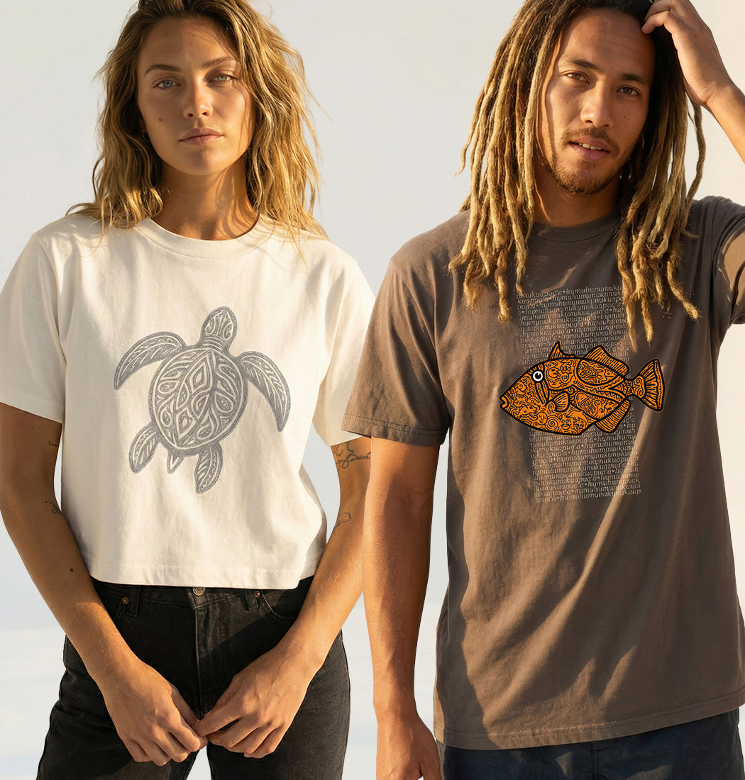 Two people wearing t-shirts with turtle and fish designs against a neutral background