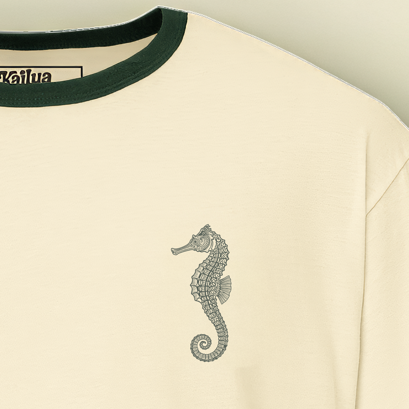 close-up of forest-green rib neckline and forest green seahorse print texture