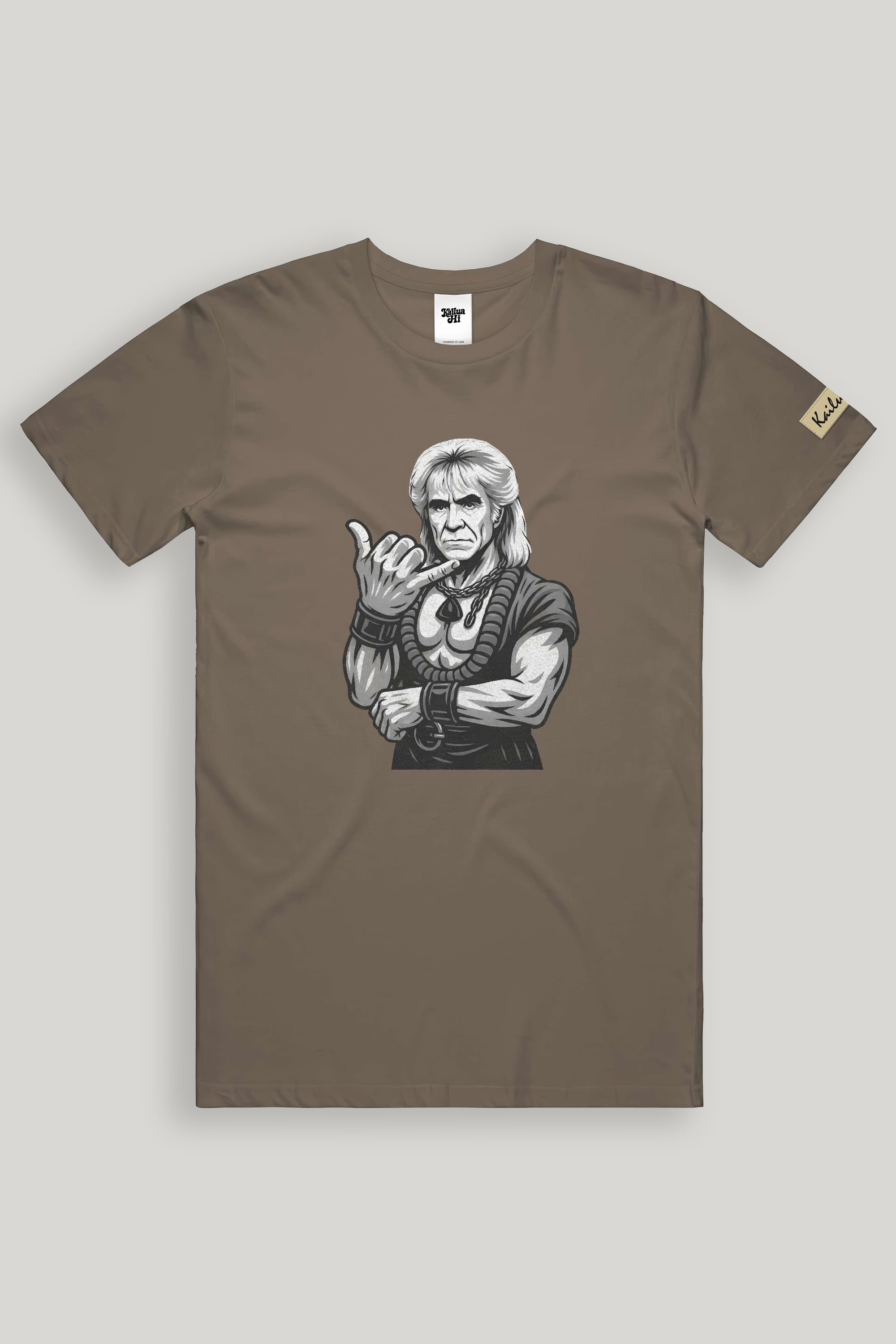 Brown shaka khan  t-shirt with graphic design of a person making a shaka hand gesture on a light gray background