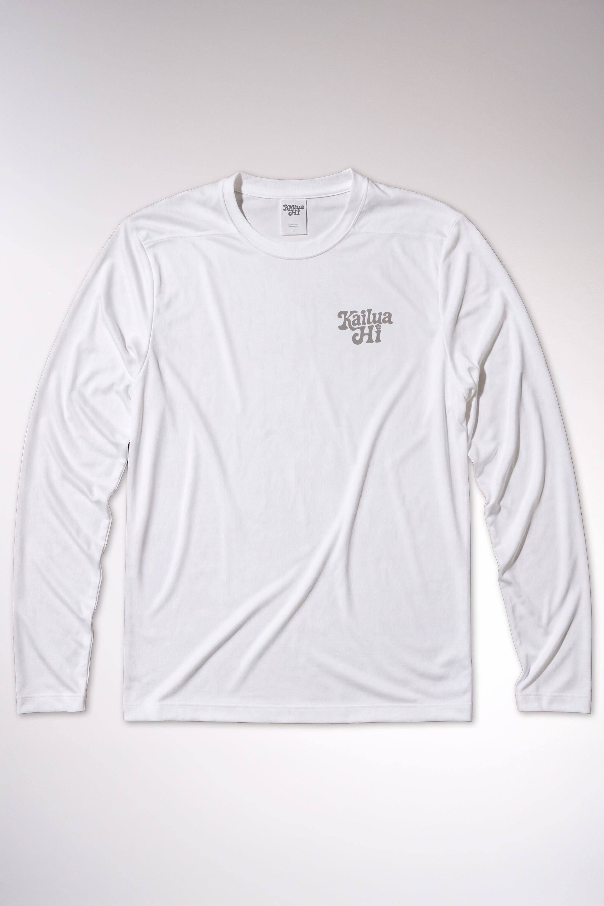 kailua hi surf tees be pono men's long sleeve upf 50 sunshirt in white – studio flat lay product shot of the front of the shirt. features a retro gray script kailua hi logo printed on the left chest, an athletic crew neckline, and a visible interior kailua hi woven neck label, showcasing the clean texture of the performance uv protective fabric against a neutral background