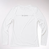 kailua hi surf tees be pono women's long sleeve upf 50 sunshirt in white – studio flat lay product shot of the back of the shirt. features the minimalist text be pono printed across the shoulders with clean horizontal accent lines, showcasing the relaxed performance fabric build and athletic crew neck against a neutral background