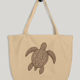 Beige tote bag with a turtle design on a light gray background