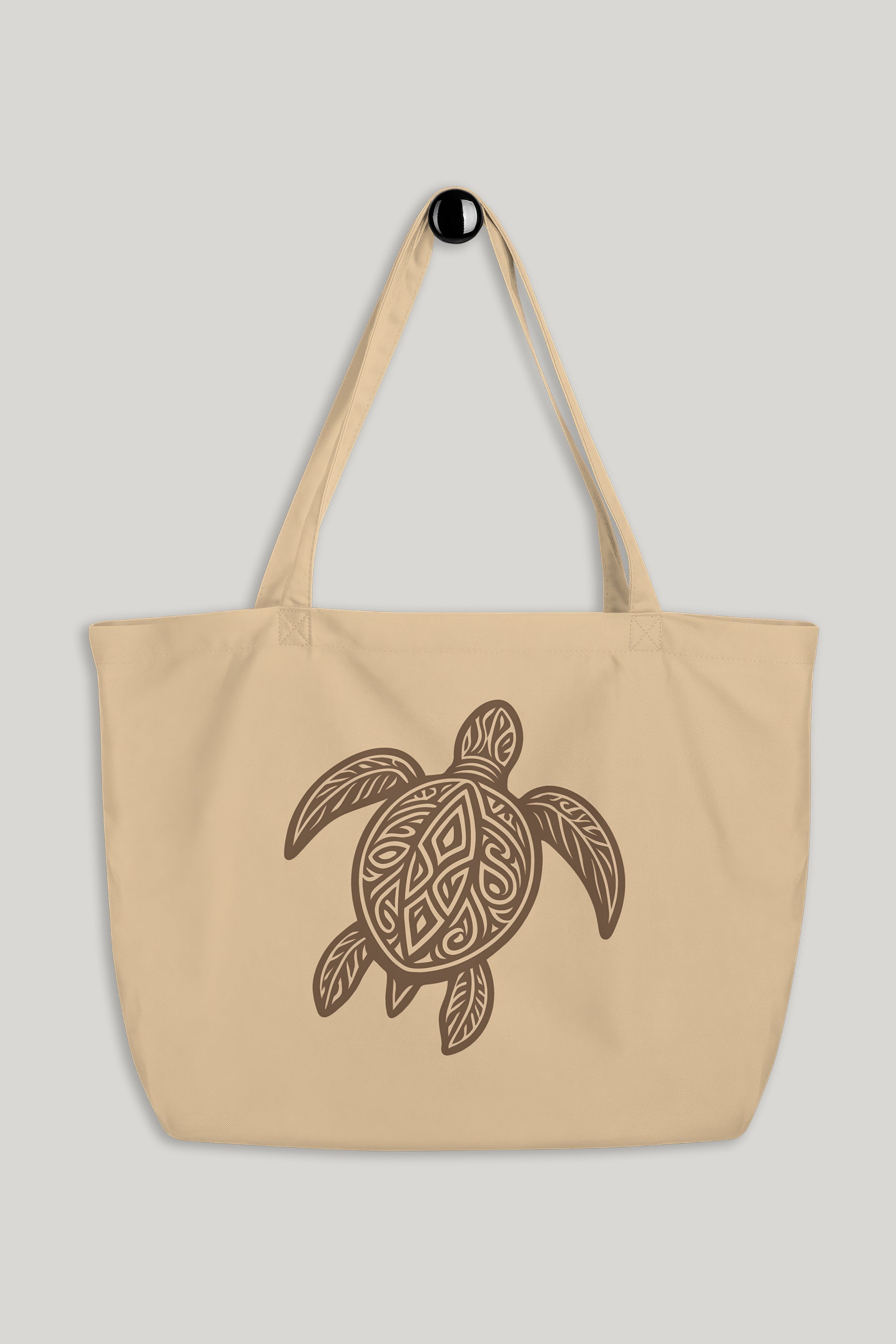 Beige tote bag with a turtle design on a light gray background