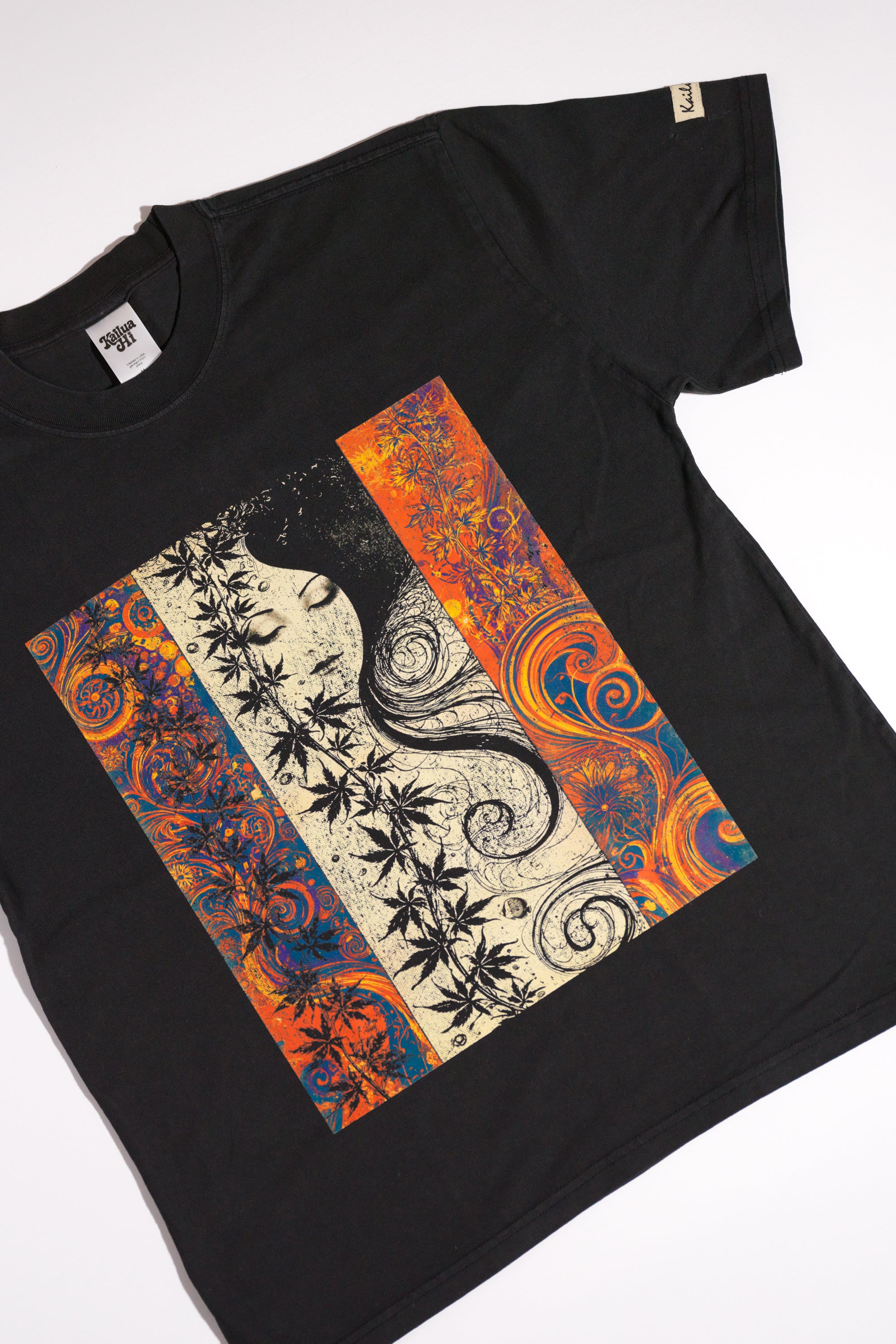 kailua hi surf tees seaweed pua o ke kai women's luxe tee in faded black – product lifestyle video showcasing the relaxed casual fit, premium fabric drape, and detailed art nouveau graphic panel featuring a woman's face and vibrant botanical leaves in motion