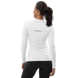 three-quarter back view of white women’s rash guard with “be pono” graphic across upper back, slim athletic fit